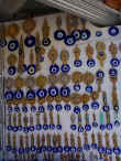 A whole wall of eye pendants reflecting all that is bad and evil