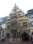 The ornate French roofline accents on Masion des tetes, or Head's House