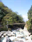 Suspension bridge above the rushing waters