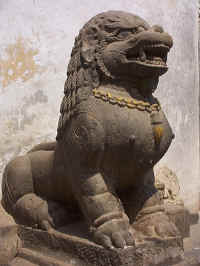 Stone lion guards the gates of a Nepalese palace