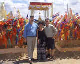 A dry John, Laura, and Scott in front of some New Year temple flags in Bangkok