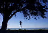 Laura enjoys a little 'swing-time' by the sea