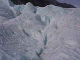 A loud, shallow 'CRUNCH' at the glacier's base