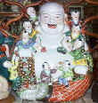 Antique Buddha statue clamoring with kids