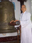 Buddist Nun (yes a nun) rings the ritualistic bell