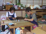 Spying on two young ladies working together to make fans